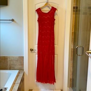 Red lace gown with nude slip.